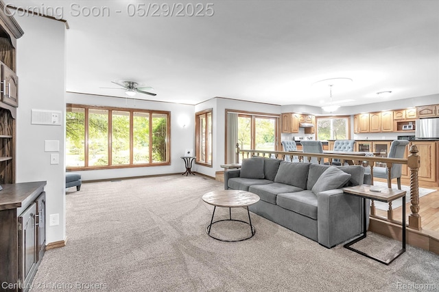 2232 Hayward St, Clio, MI 48420 - living area featuring a ceiling fan, light colored carpet, and baseboards