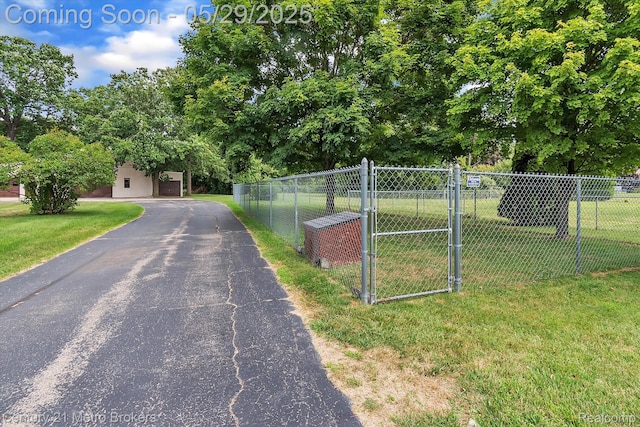 2232 Hayward St, Clio, MI 48420 - view of asphalt driveway featuring a gate