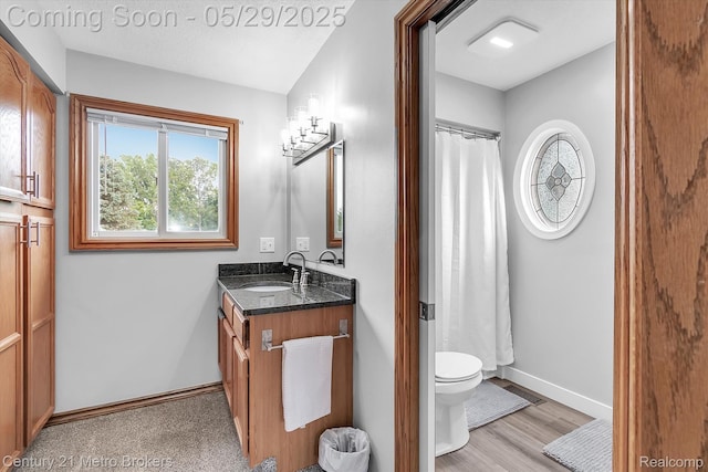 2232 Hayward St, Clio, MI 48420 - bathroom with vanity, toilet, baseboards, and wood finished floors