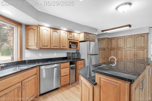 2232 Hayward St, Clio, MI 48420 - kitchen with stainless steel appliances, a sink, light wood-style flooring, and dark stone countertops