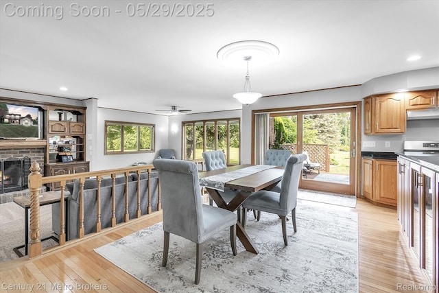 2232 Hayward St, Clio, MI 48420 - dining room featuring light wood finished floors, recessed lighting, a brick fireplace, and ceiling fan