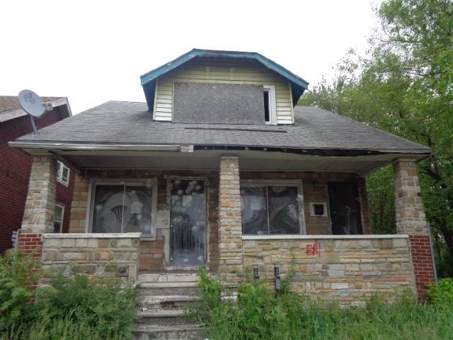 14876 Wisconsin St, Detroit, MI 48238 - bungalow-style home with roof with shingles, a porch, and stone siding