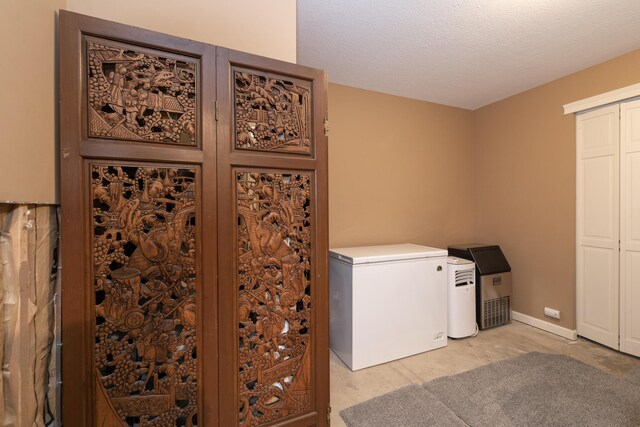 7130 Riesling St, Michigan, MI 49071 - laundry area with a textured ceiling and light carpet