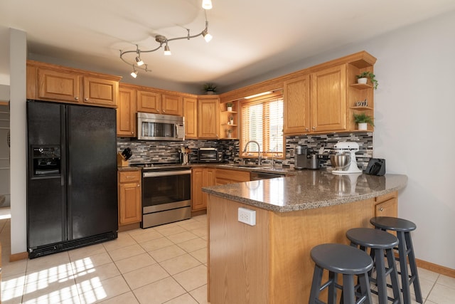 7130 Riesling St, Michigan, MI 49071 - kitchen with open shelves, stainless steel appliances, a sink, a peninsula, and light tile patterned floors