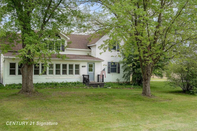 3320 N Sturgeon Rd, Midland, MI 48642 - back of property featuring a lawn and roof with shingles