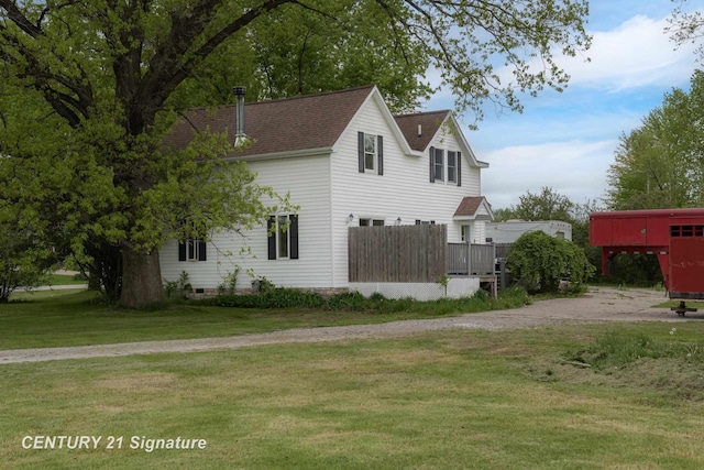 3320 N Sturgeon Rd, Midland, MI 48642 - view of side of property with a lawn, a shingled roof, and driveway