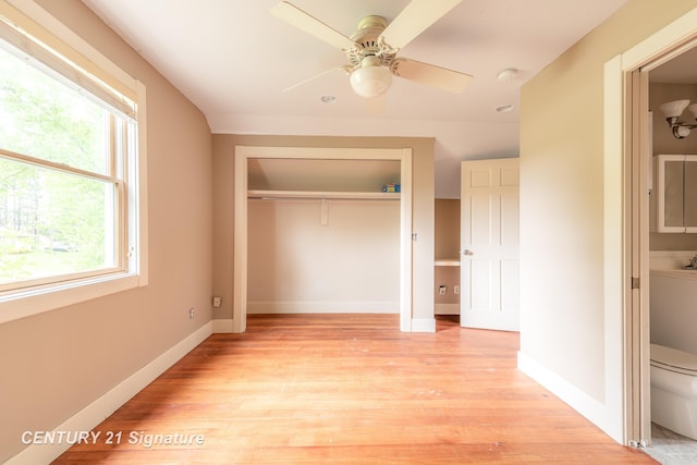 3320 N Sturgeon Rd, Midland, MI 48642 - unfurnished bedroom featuring a closet, light wood-style floors, baseboards, and ceiling fan