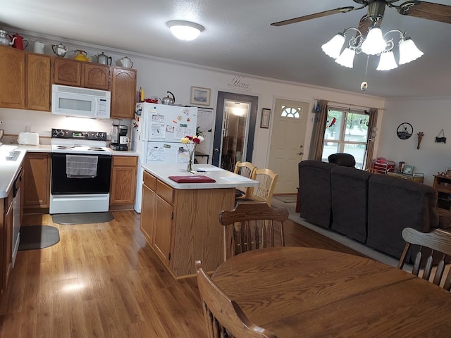 1946 Catherine Ave, Muskegon, MI 49442 - kitchen featuring white appliances, a ceiling fan, light countertops, light wood-style flooring, and a kitchen island