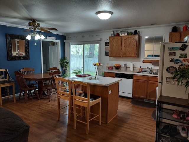 1946 Catherine Ave, Muskegon, MI 49442 - kitchen with white appliances, a sink, light countertops, ornamental molding, and a ceiling fan