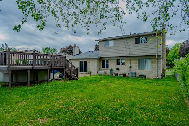 32904 Surow Dr, Warren, MI 48093 - rear view of house with a deck, brick siding, stairway, central AC, and a chimney