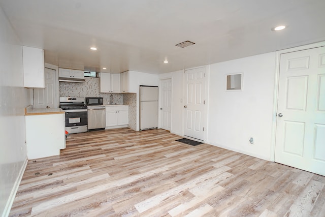 32904 Surow Dr, Warren, MI 48093 - kitchen with appliances with stainless steel finishes, light wood finished floors, light countertops, white cabinets, and recessed lighting