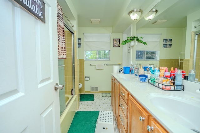 32904 Surow Dr, Warren, MI 48093 - bathroom featuring double vanity, toilet, baseboards, and bathtub / shower combination