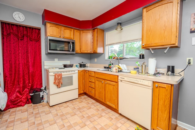 32904 Surow Dr, Warren, MI 48093 - kitchen featuring white appliances, light countertops, a sink, and brown cabinetry