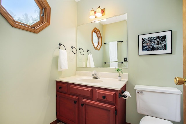 half bathroom featuring toilet and vanity