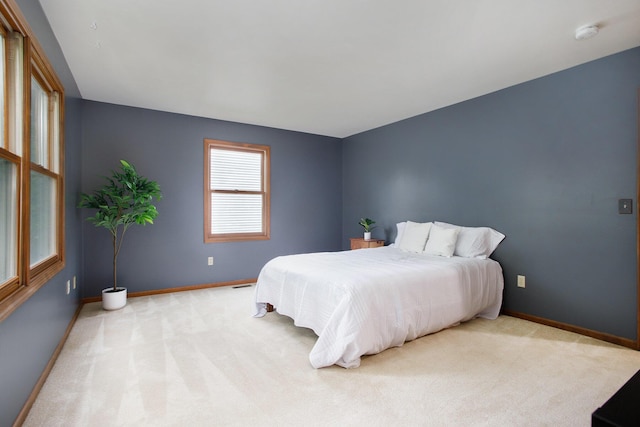 bedroom with carpet flooring and baseboards