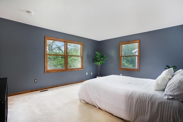 carpeted bedroom featuring baseboards