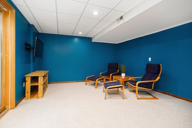 sitting room featuring carpet, baseboards, recessed lighting, and a paneled ceiling