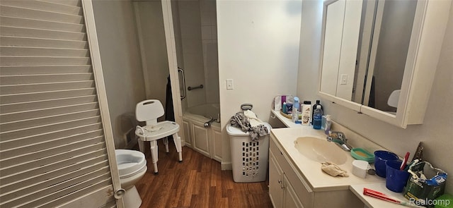 5471 Fairhaven St, Flint, MI 48505 - bathroom featuring vanity, wood finished floors, toilet, and shower / washtub combination