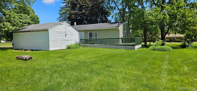 5471 Fairhaven St, Flint, MI 48505 - back of house featuring a yard and a wooden deck