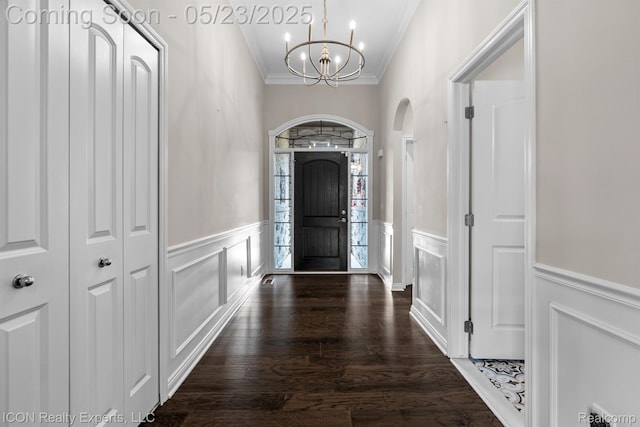 14153 Jode Park, Utica, MI 48315 - foyer with crown molding, a chandelier, a wainscoted wall, arched walkways, and wood finished floors
