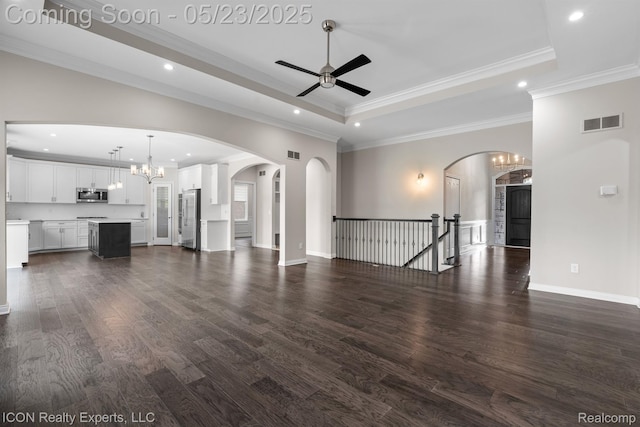 14153 Jode Park, Utica, MI 48315 - unfurnished living room featuring a ceiling fan, a tray ceiling, recessed lighting, arched walkways, and a chandelier