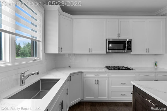 14153 Jode Park, Utica, MI 48315 - kitchen with stainless steel appliances, a sink, white cabinets, light stone counters, and backsplash