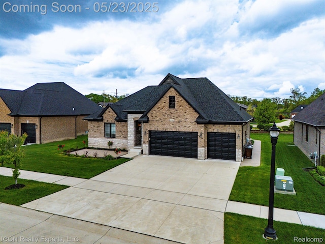 14153 Jode Park, Utica, MI 48315 - french country inspired facade featuring brick siding, concrete driveway, a front yard, and an attached garage