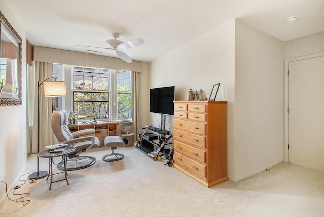 sitting room with carpet floors, ceiling fan, and baseboards