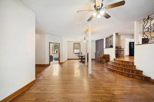 113 W Chicago St, Buchanan, MI 49107 - living room with a ceiling fan, wood finished floors, baseboards, and a textured ceiling