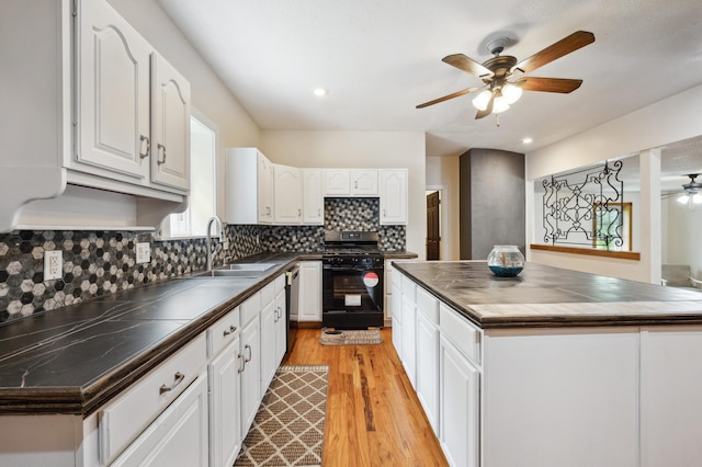113 W Chicago St, Buchanan, MI 49107 - kitchen featuring black gas stove, ceiling fan, a sink, white cabinetry, and light wood-style floors