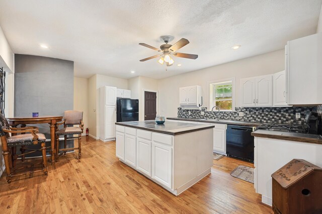 113 W Chicago St, Buchanan, MI 49107 - kitchen with black appliances, dark countertops, ceiling fan, a kitchen island, and recessed lighting