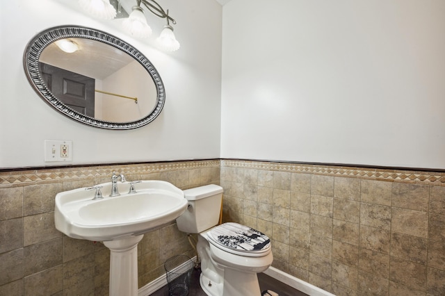 113 W Chicago St, Buchanan, MI 49107 - half bath with tile walls, a wainscoted wall, and toilet