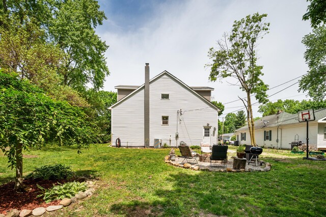 113 W Chicago St, Buchanan, MI 49107 - rear view of property with a lawn, a chimney, and a patio