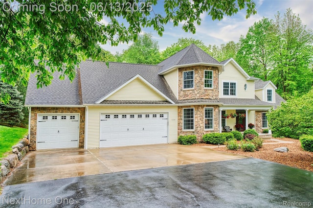 17351 Timber Crk, Holly, MI 48442 - view of front facade with stone siding, driveway, a garage, covered porch, and roof with shingles