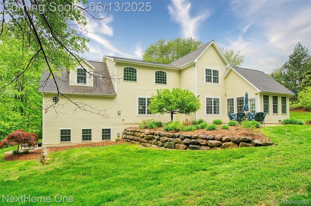 17351 Timber Crk, Holly, MI 48442 - back of property with a lawn and a shingled roof