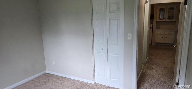 995 N Cass Lake Rd Unit 233, Waterford, MI 48328 - unfurnished bedroom with carpet, baseboards, and a closet