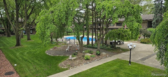 995 N Cass Lake Rd Unit 233, Waterford, MI 48328 - view of home's community featuring a pool and a yard