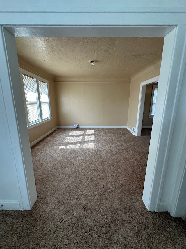 9982 Littlefield St, Detroit, MI 48227 - carpeted empty room featuring baseboards and a textured ceiling