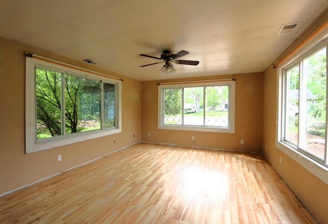 spare room with light wood-style floors and ceiling fan