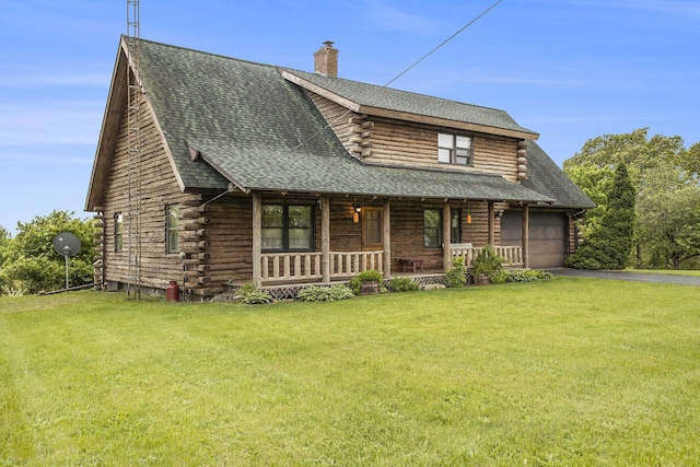 log cabin featuring log siding, covered porch, a front yard, and a chimney