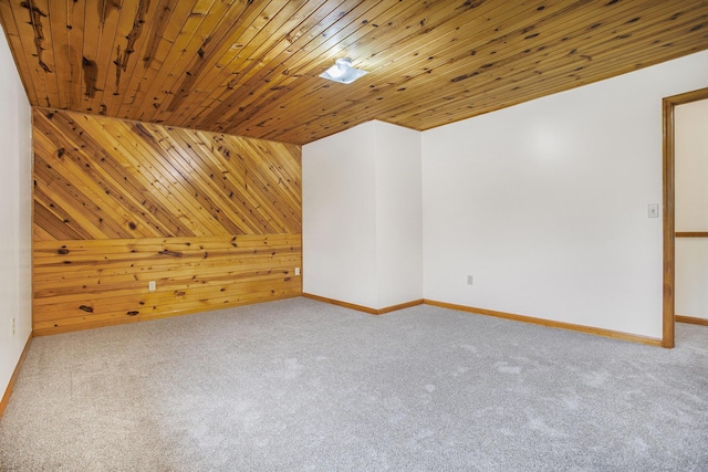 bonus room featuring carpet, wooden walls, wooden ceiling, and baseboards