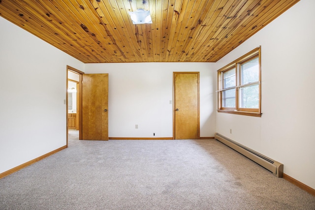 unfurnished room with a baseboard heating unit, light colored carpet, wooden ceiling, and baseboards