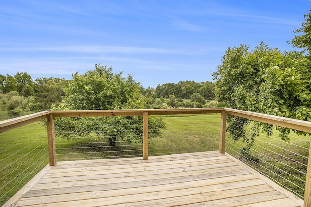 wooden terrace featuring a lawn