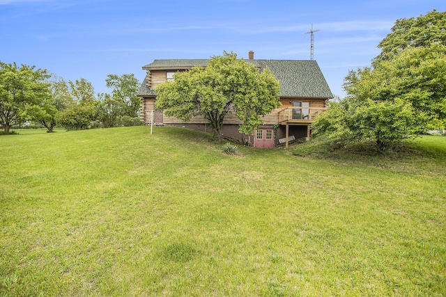 view of grassy yard featuring a wooden deck