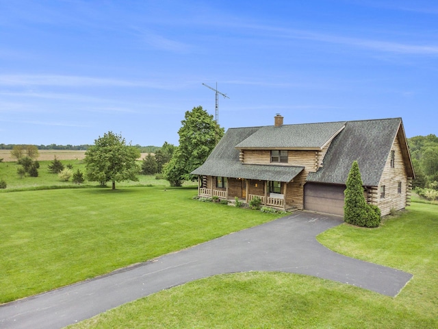 cabin with covered porch, a chimney, a front lawn, asphalt driveway, and a shingled roof