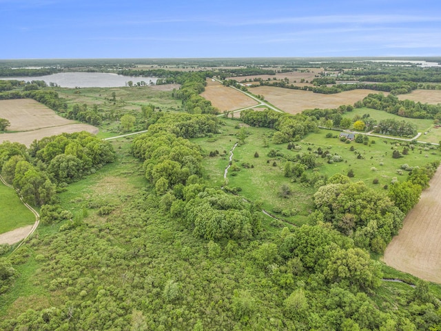aerial view of property's location with a nearby body of water and rural landscape