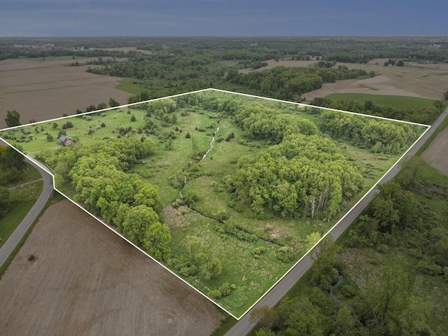 aerial view of property and surrounding area with property parcel outlined and rural landscape