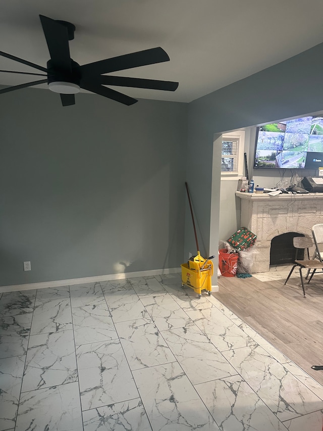 17532 Russell St, Highland Park, MI 48203 - unfurnished living room with marble look tile flooring, baseboards, and ceiling fan
