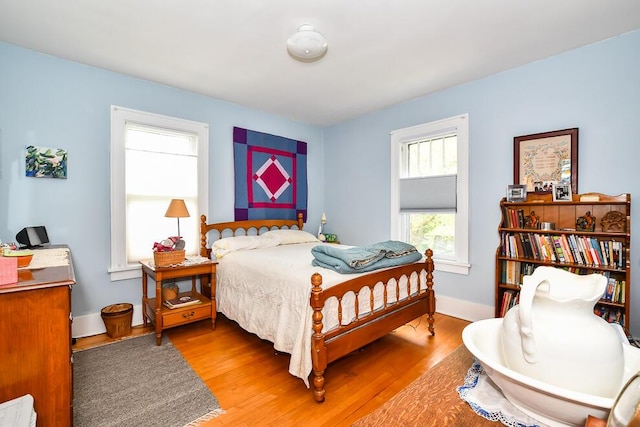 bedroom with wood finished floors and baseboards