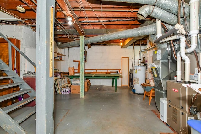 unfinished basement featuring water heater, concrete block wall, and heating unit